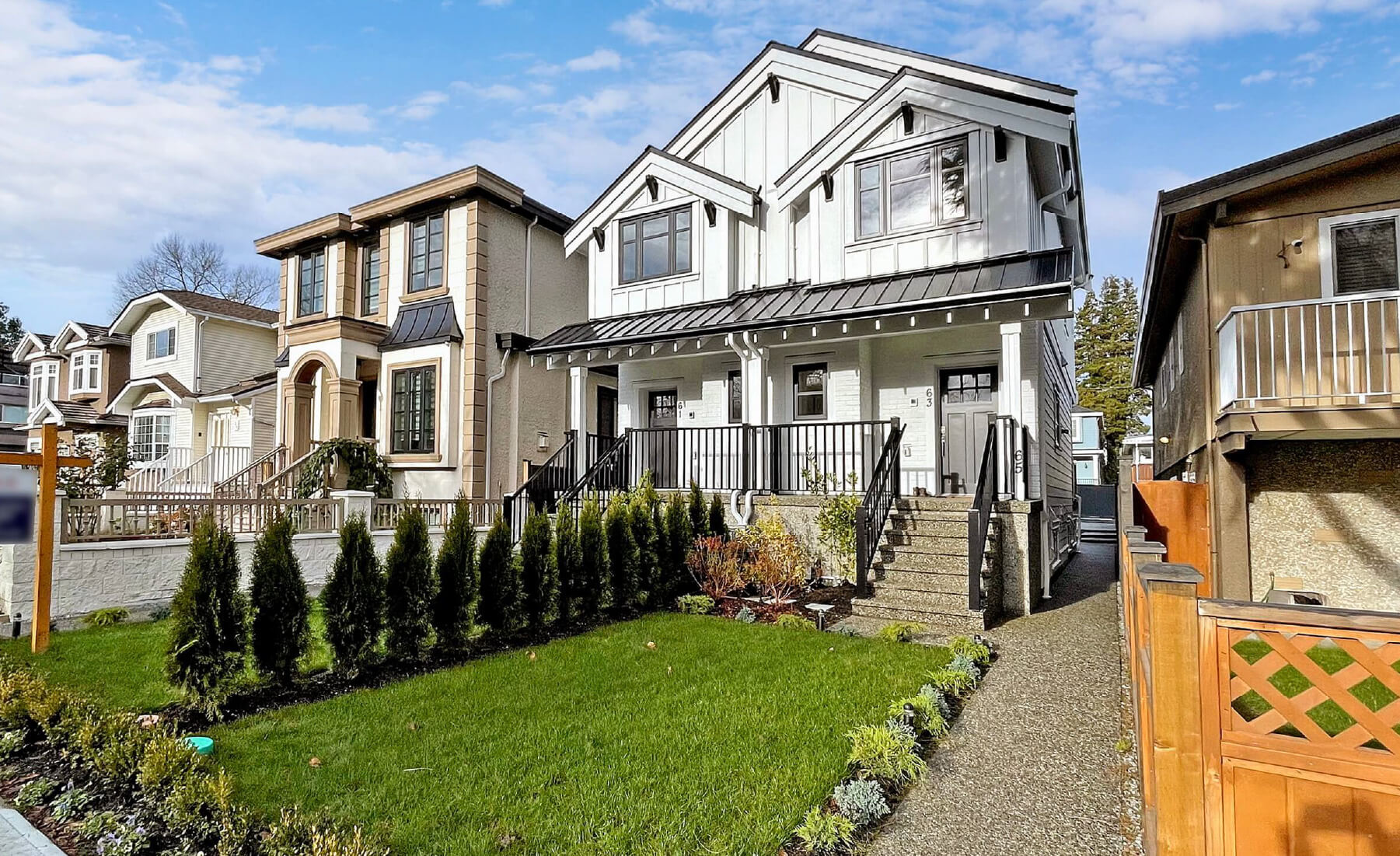 row of houses with white duplex featured in middle. Neighbourhood view