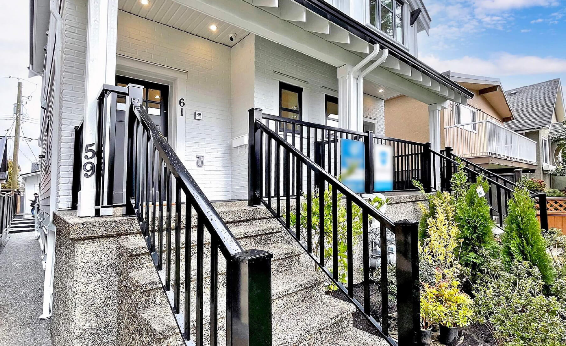 front porch with black railing and stairs