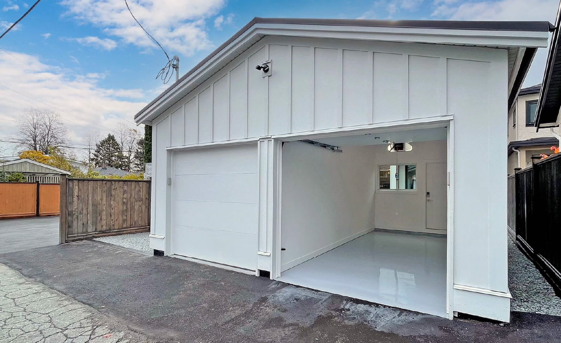 detached  2 car garage, alley view. white siding black trim 